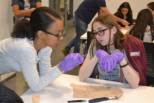 ECE PhD student Lonna Edwards (left) works with Madelyn Hogg, helping her get her solar cell correct in order to test it.