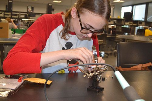 Danville native Madeline Hogg tries her hand at soldering.