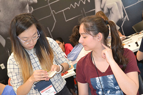 Wynter Chen checks out a student's work on her circuit.