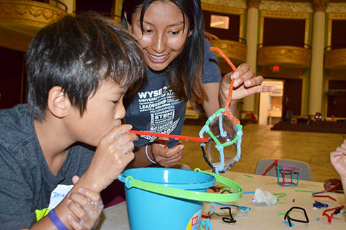 Adriana Carola Salazar Coariti (right) works with a youngster during the Orpheum outreach.