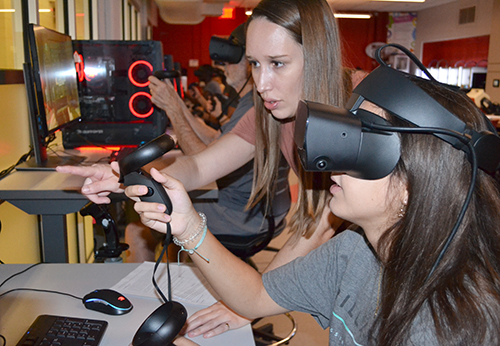 Tricia Thrasher (left) helps a French 205 student figure out how to use vTime at CITL's Innovation Studio. 