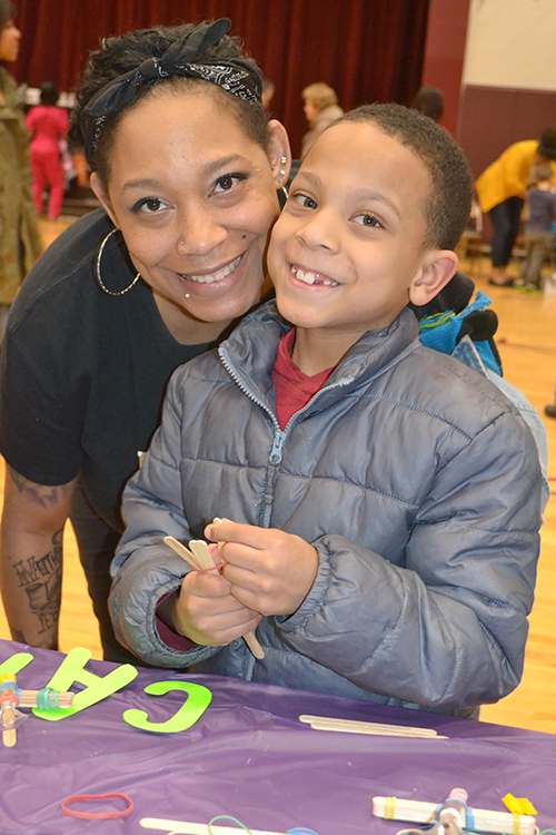 Shenill Hill and her son Journey, who's building a catapult at STEAM Night.