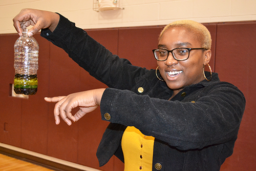 An Illinois student exhibits what the Rainbow Jar station helped the kids make.