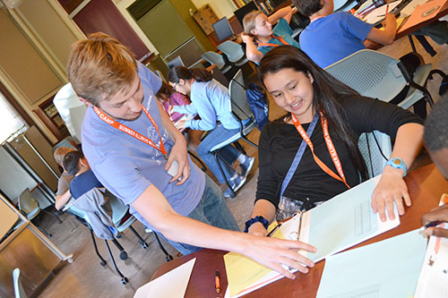 Jack Gentile works with Lisa Spencer on a coding activity.