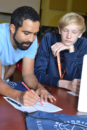 Nicholas Bodony and Fernando Roman work on an activity.