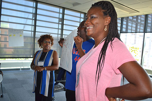 Lillian Perteete (right), a counselor at Chicago Vocational Career Academy and her teammates present their poster on students’ perception of STEM.