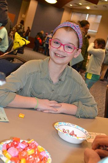 A local middle schooler enjoys one of the carnival's candy games.