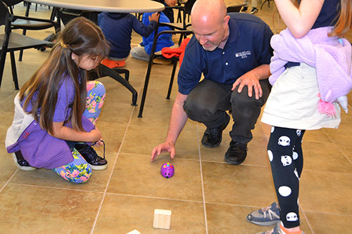 Adam Scott helps students test the programming on their mouse robot.