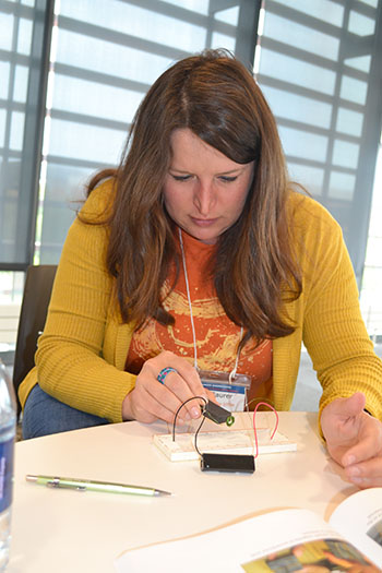 Irica Baurer, an arts instructor at Sarah E. Goode STEM Academy works on the breadboard hands-on activity.
