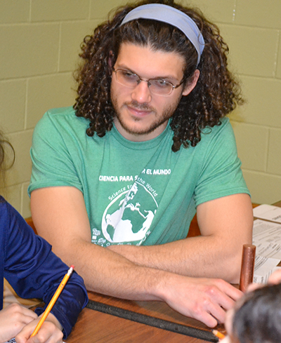 Illinois grad student Luis M. de Jesus Astacio works with youngsters during a February 2020 Cena y Ciencias at Dr. Preston Williams School.