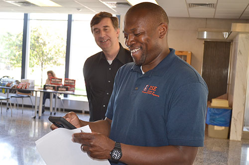 Joe Muskin and Joe Bradley (right), watch a team's video presentation.