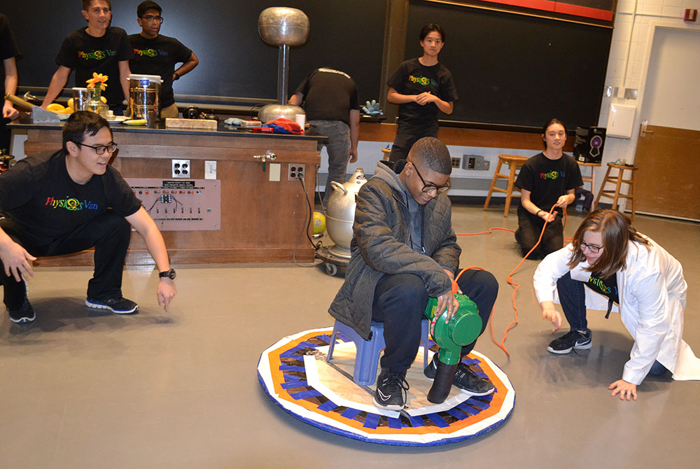 Spencer Hulsey demonstrates how the Van de Graaff Generator can cause one's hair to stand on end.