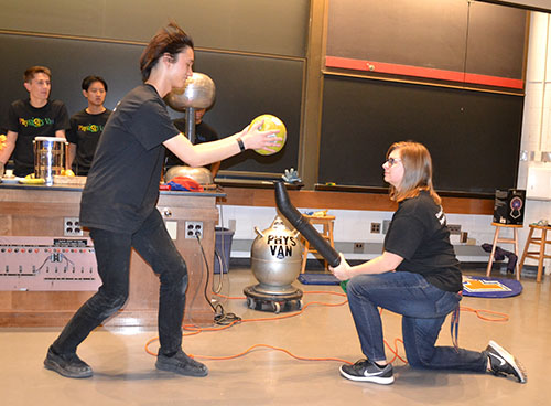 Physics Van co-coordinator Spencer Hulsey and a volunteer do a demo illustrating Bernoulli's principle