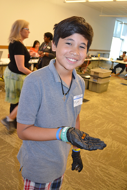 Elijah Olayo shows off the Batmobile he 3D printed.