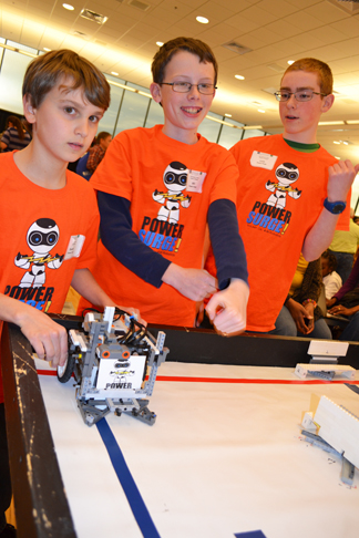 Members of the PowerSurge robotics team prepare to compete.