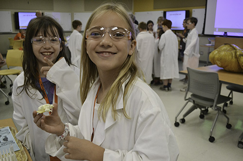 Rayna tasting butter that she made from shaking cream at the ACES lab