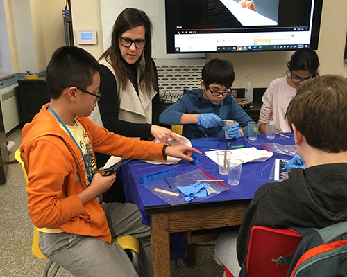 Holly Golecki (second from the left) works with Uni High students doing soft robotics hands-on activities. (Image courtesy of Holly Golecki.)