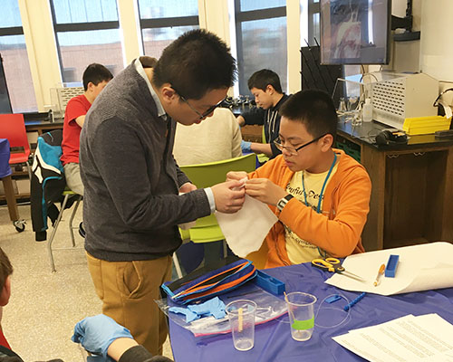 Tianshi Fu (left) helps a Uni High student doing one of the soft robotics hands-on activities during Agora Days. (Image courtesy of Holly Golecki.)