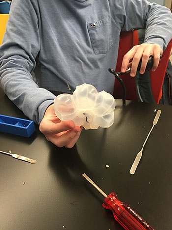 A Uni High student displays the RIA (Removable Insert Actuator) he made. (Image courtesy of Holly Golecki.) </div>