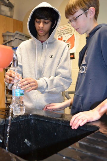 Two contestants prepare their Cartesian Diver for the 
