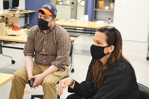 Elisandro Cabada and Holly Golecki chat with the 3D Bioprinter team during their demonstration.