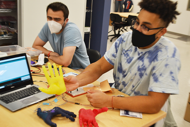 Riley Lehmann and Preston Njapa Njeuha demonstrate their Prosthetic Robotic Hand.