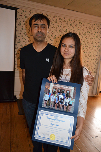 A high school student (right) poses with and her father at the Sustainable Futures Final Presentation event.
