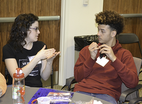 An Illinois student discusses the activity with one of the participants at DNA & Health Day.