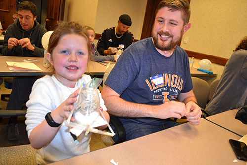 One local girl and her dad put the finishing touches on their egg-drop machine. 