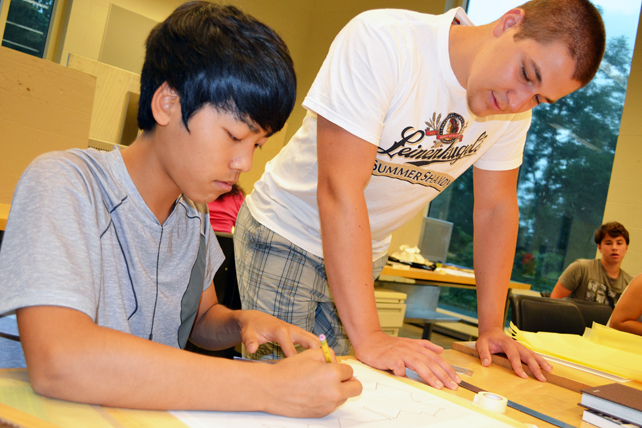 Ryan Doidge (right) helps a Discover Architecture student.