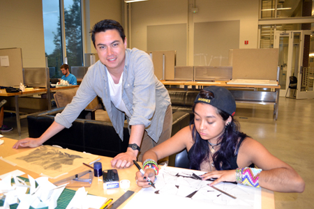 David Emmons looks at a student's work during one of the camps hands-on sessions.