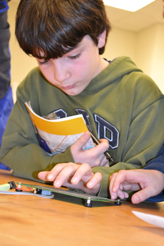 Springfield youth tinkers with circuits during the 2014 EOH.