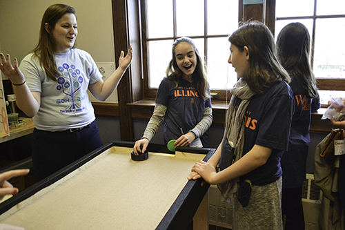 Abby Pakeltis interacting with EOH visitors playing at the air hockey table she helped build.