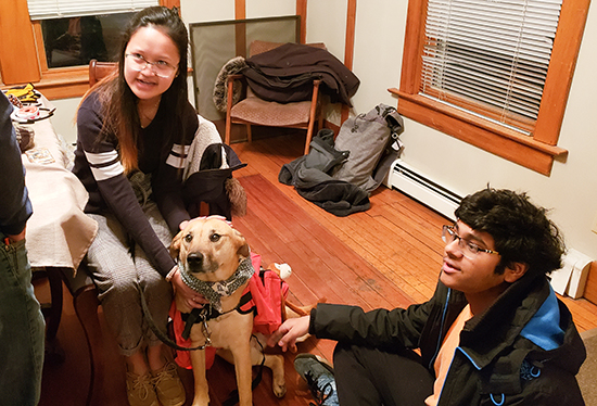 Lauren Gil and Suva Narayan pet Penny as she waits for EEG testing. (Image courtesy of Joseph Sim.)