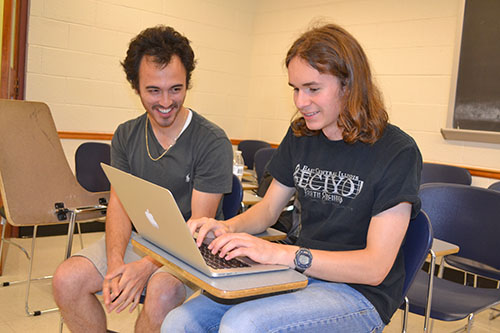 Caption: James Schmidt interacts with a Uni High student doing research about theorems and conjectures.