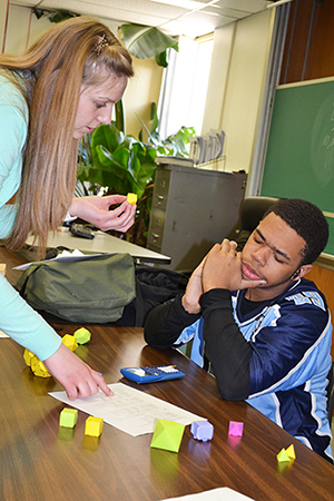 Allison Rogala helps a student during a hands-on activity at Tap-In.