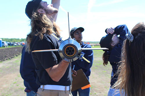 Members watching a rocket being launched.