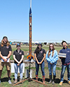 Members of the ISS High-Power Rocketry team show off their prize-winning rocket. 