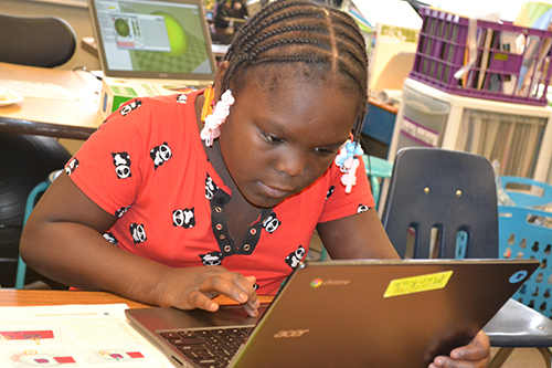 A King student uses TinkerCAD to design her keychain during the 3D printing activity.