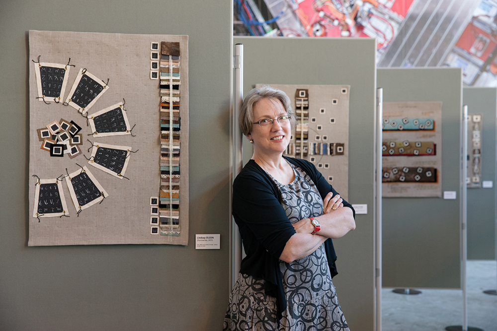 Lindsay Olson at CERN in 2015 during an exhibit of her SciArt. (Image courtesy of Bree Corn.)