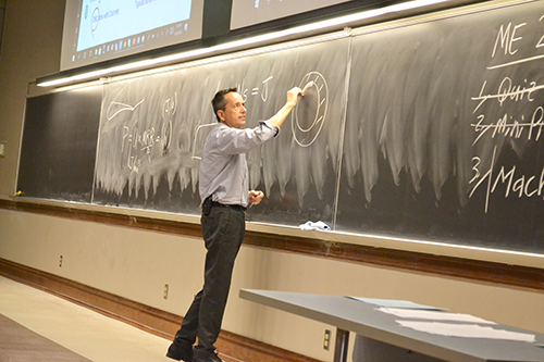 Professor Leon Liebenberg explaining something on the board while teaching his ME270 course.