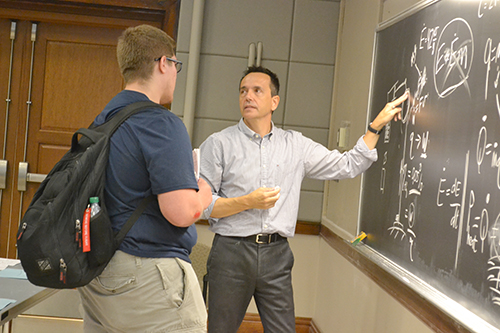 Professor Leon Liebenberg explaing a question to a student.