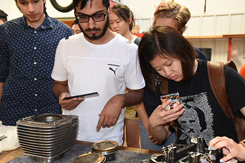 Students look at different mechanical parts.