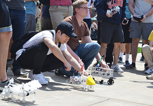 Two ME370 students prepare to race their teams' automata