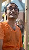 MechSE Professor Sameh Tawfick glances up at the water balloons poised in the drenching booth's apparatus above him.