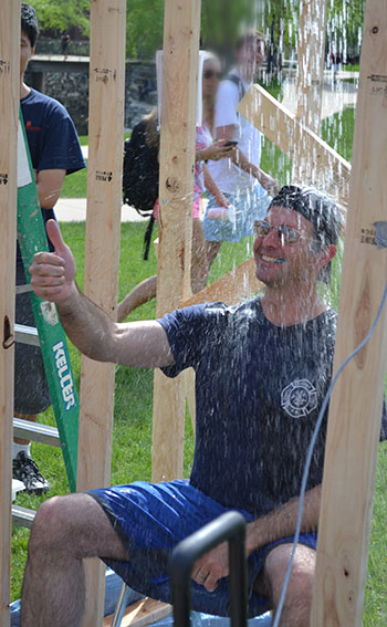 MechSE Professor Gavin Horn gives the team that dunked him a thumbs up. 