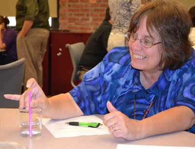 Teacher performs procedure during the chemistry breakout session.