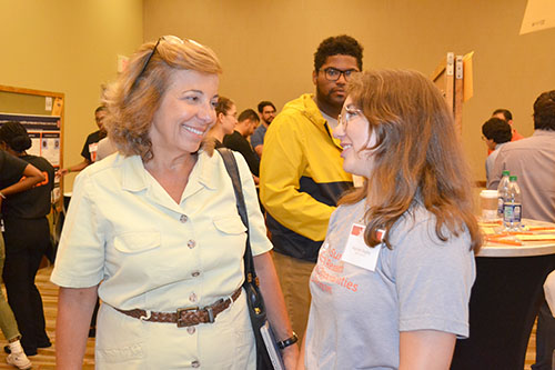 PI Marina Marjanovic chats with Hannah Bagley at the Illinois Summer Research Symposium.