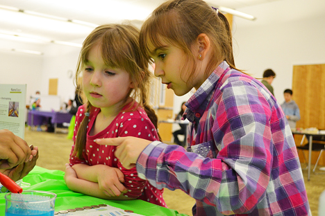 Katrina (right) and a friend watch as electroplating.