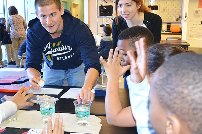 Two NanoSTRuCT grad students engage the BTW 3rd graders during a demonstration.